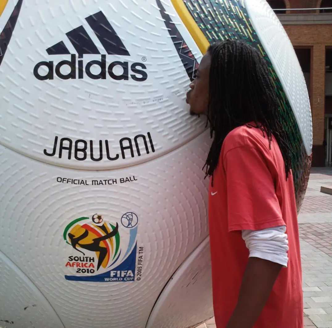 Football lover kissing a giant ball